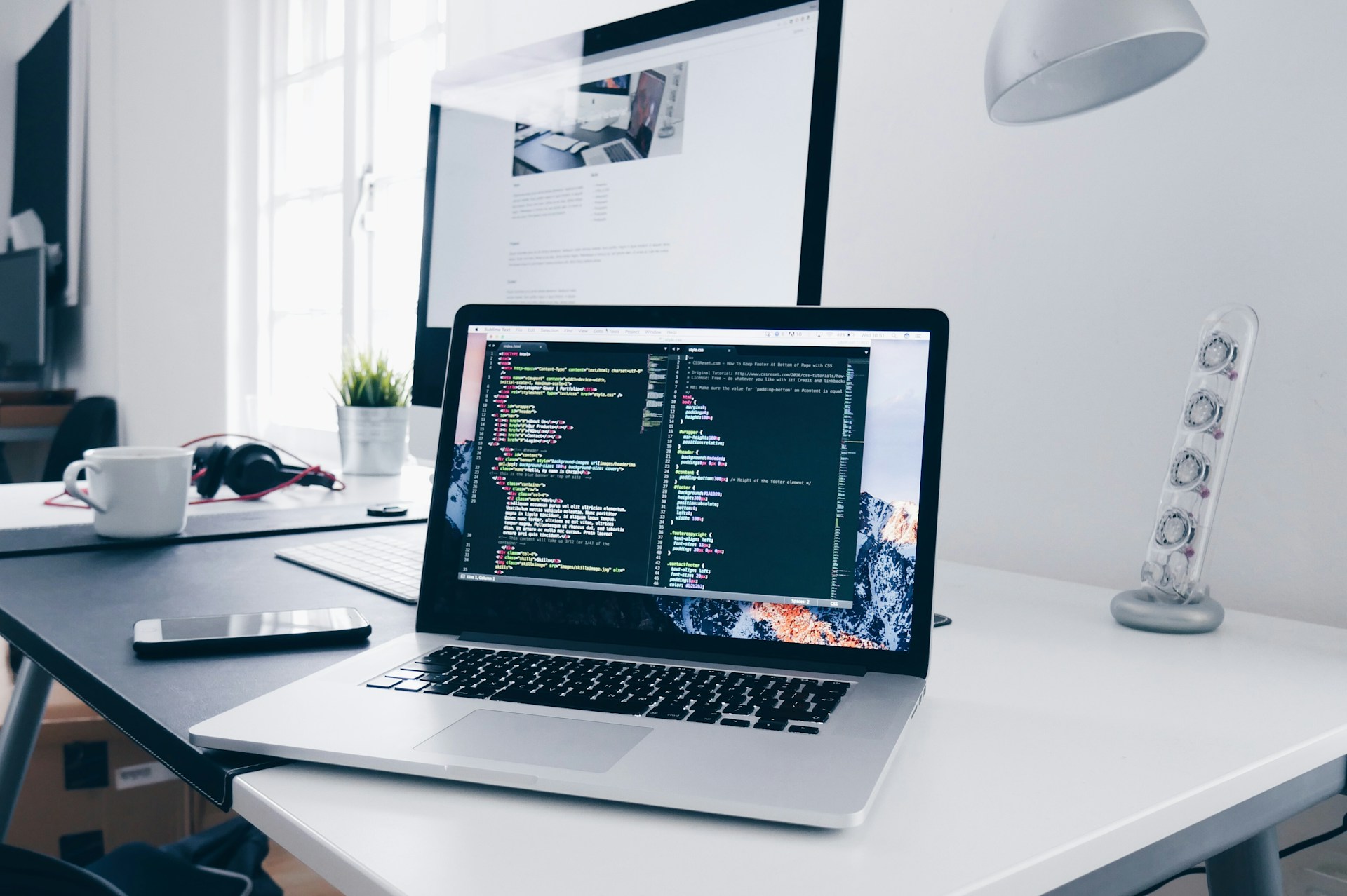 A real coding workstation with source code open on a laptop